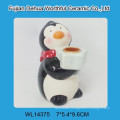 Ceramic candle holder with penguin design